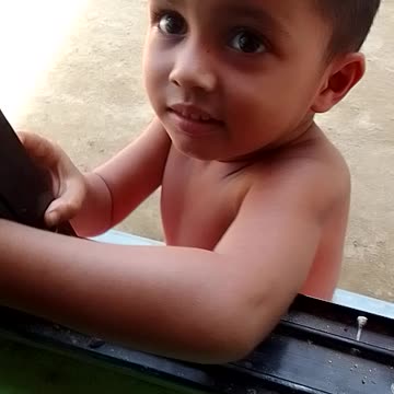 Cute kids play with window glass