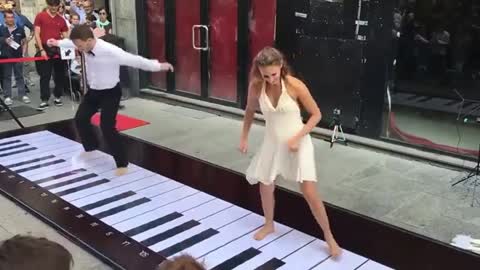 Must see a couple doing a lovely performance on a giant floor piano.