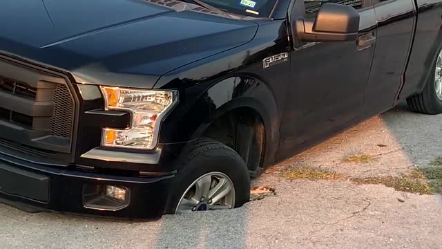 Giant Hole in Houston Traps Truck