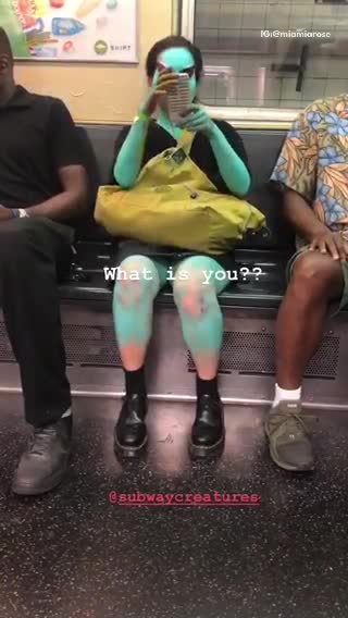 Woman subway blue skin body paint green bag