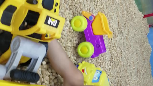 Smart toddler playing with material excavator at supermarket - part 3