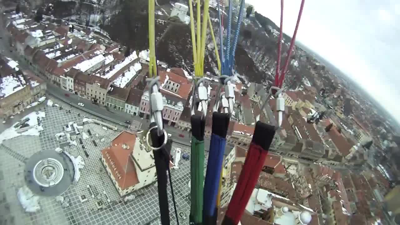 Paragliding above a snow-covered city in Transylvania