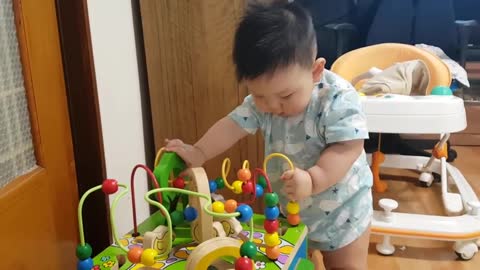 Cute baby playing with toys.