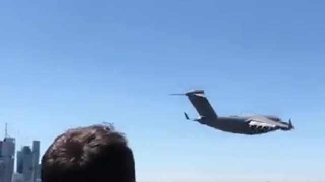 The plane flies over the city