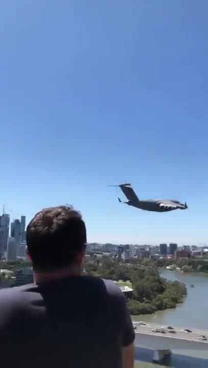 The plane flies over the city