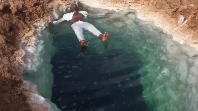 Floating in the salt water siwa osasis in Egypt