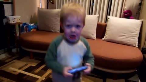 Toddler makes angry face when he dances