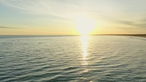 Sunrise over ocean waves