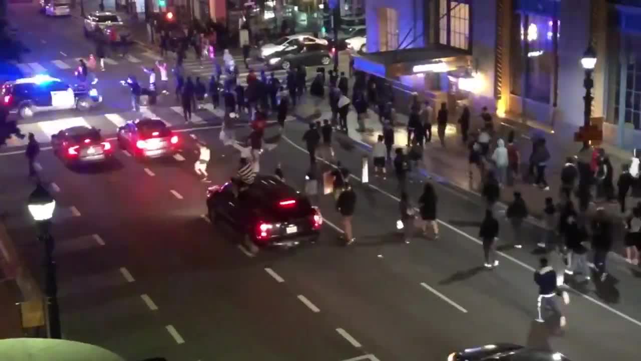 Police SUV runs through crowd crossing the street