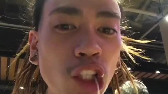 Guy slurping long noodle spits and coughs out