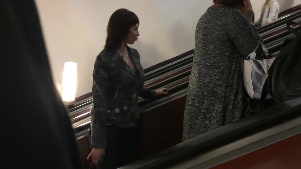 Woman caught dancing on escalator by herself