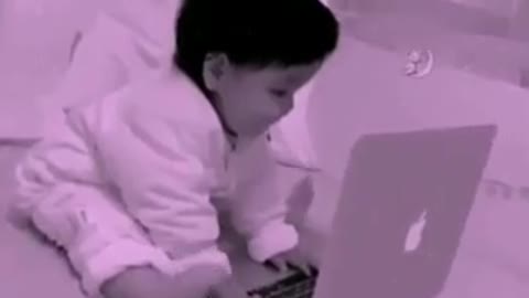 Funny baby playing computer