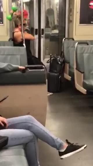 Woman uses green hand weight on the subway