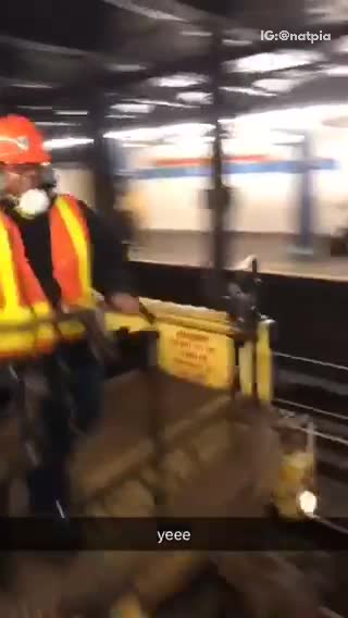 Yeee construction worker high fives man on subway terminal