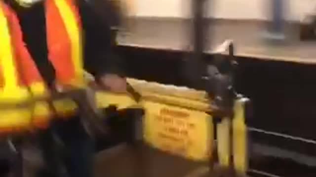 Yeee construction worker high fives man on subway terminal