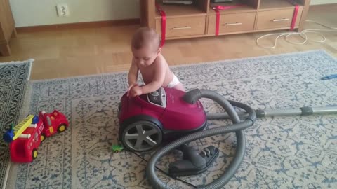 Viral Cute baby plays with a vaccum cleaner