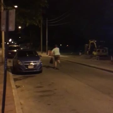 Guy skateboards green shirt light on helmet