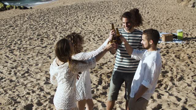 Four People Holding Beer Cheers Together