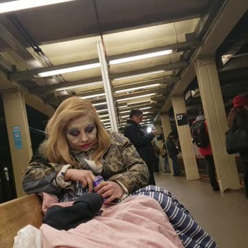 Woman puts on a lot of makeup and looks like a clown, subway station