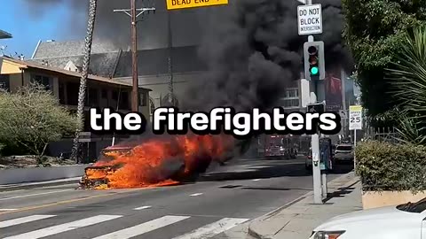 A burning car in the middle of Street