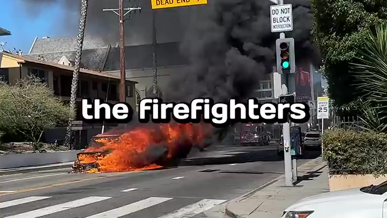 A burning car in the middle of Street