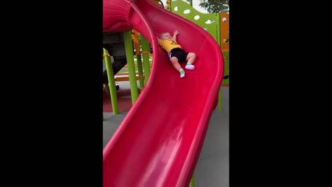 Baby Justin having first slide ride