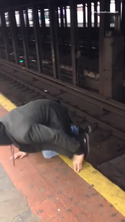 Drunk man and woman walk through nyc subway train tracks, very dangerous