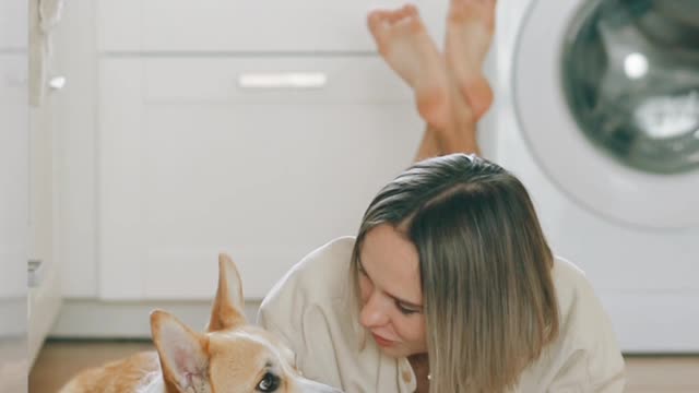 A girl and her dog using laptop