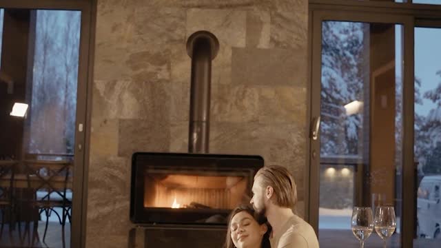 couple-sitting-in-front-of-a-fireplace