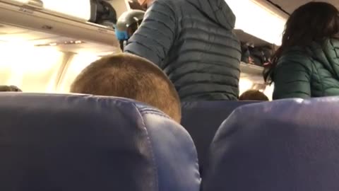 Woman wears ski gear on airplane