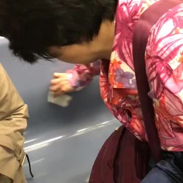 Woman in pink cleans subway chair