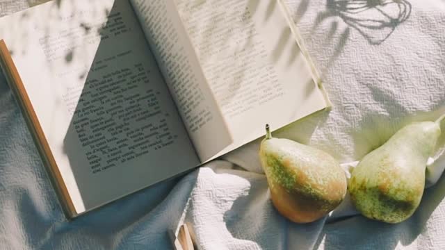 a-close-up-video-of-a-book-on-a-white-cloth
