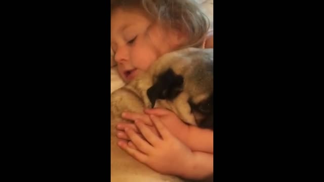 The dog snuggled up to the little girl