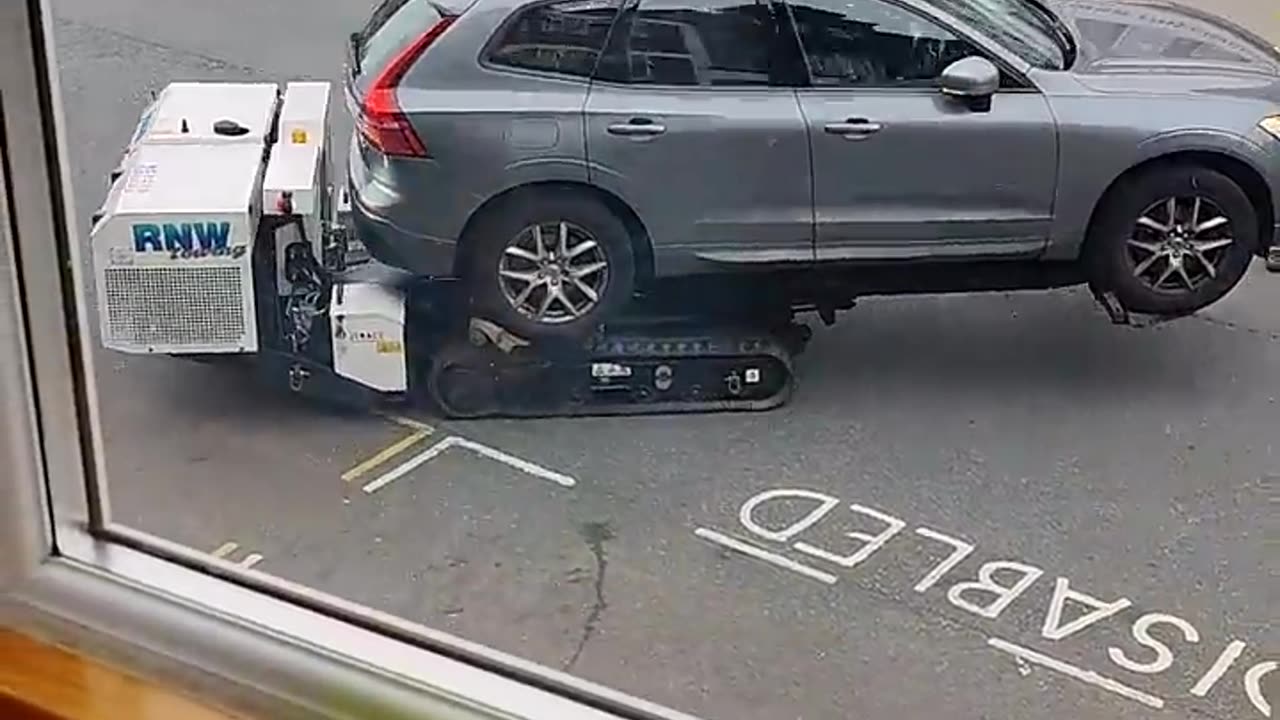 Robot removes car from disabled parking spot