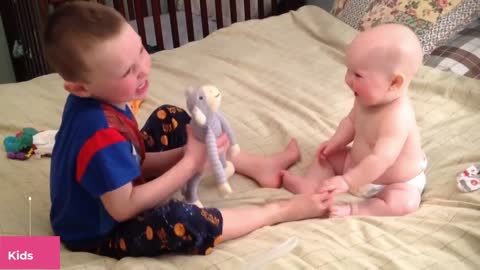 Amusingly his little brother tries to cheer up smile, smile at his little brother