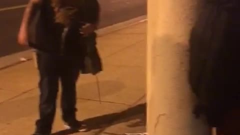Guy black shirt throwing up on street