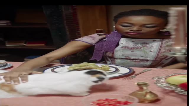 Woman Petting Her Cat On The Dining Table..Cat Licking The Crystal Glass On Top Of The Table