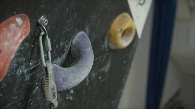 Close-up Shot of a Man's Hands Holding Wall Climbing Grips