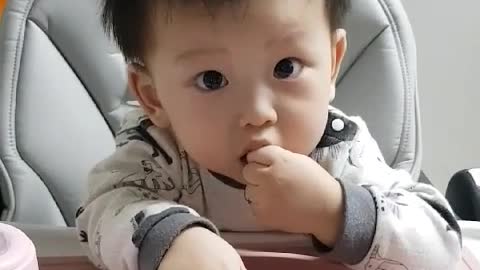 A baby eating cheese