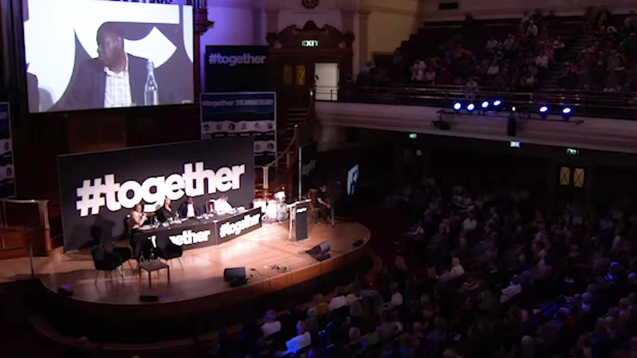 ADAM BROOKS reading questions from the floor at our Together 3rd Anniversary Event