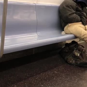 Man scratches butt on subway car