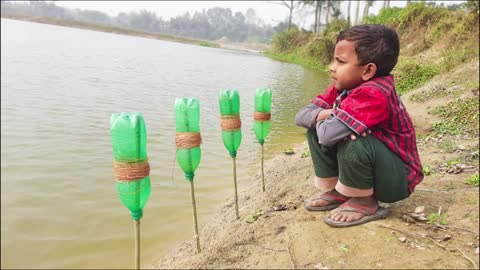 Traditional Boy Catching Big fish With Plastic Bottle Fish Hook in River