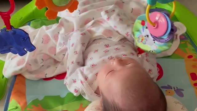 An asian baby girl is playing a piano.