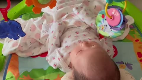 An asian baby girl is playing a piano.