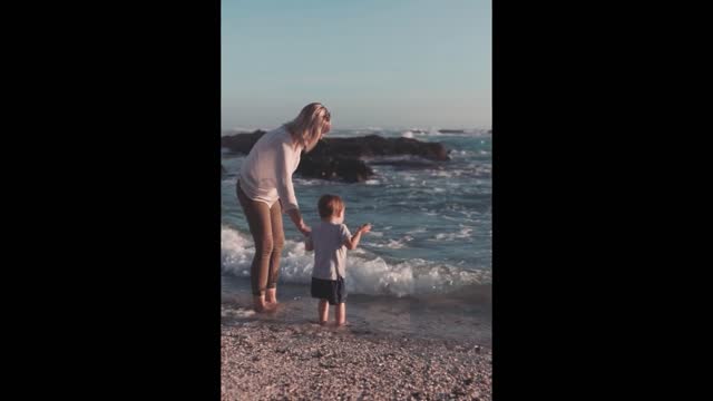 Mother And Son Playing On The Seashore