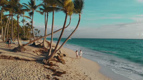 Lovely couple waking up hand in hand on a beach