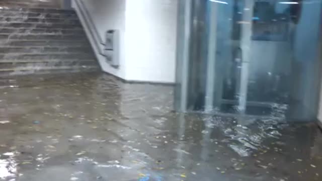 Flood waters going down stairs into subway