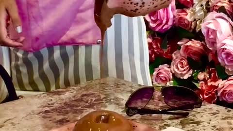 Person Pouring Chocolate on a Dessert