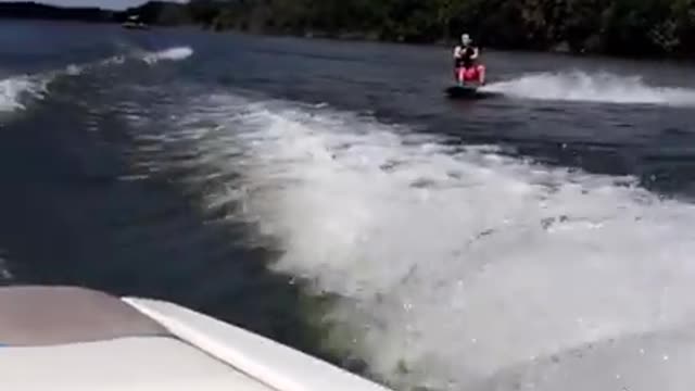 Red shorts wake board faceplant