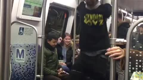 Guys in black and yellow shirts perform on subway train